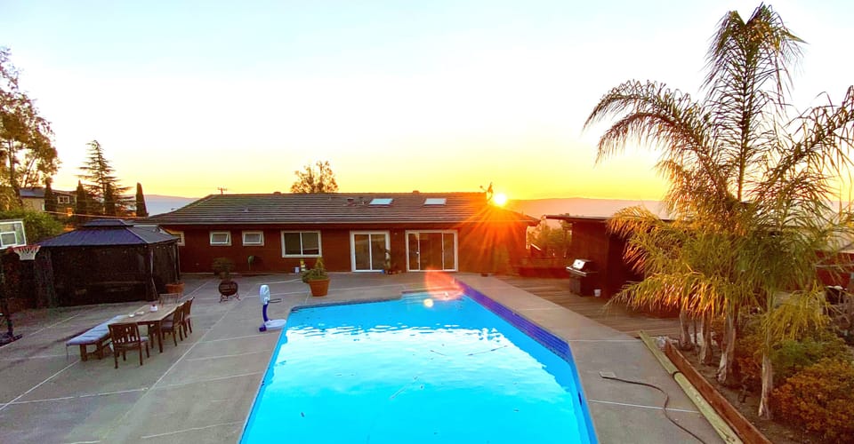 Pool and yard at sunset