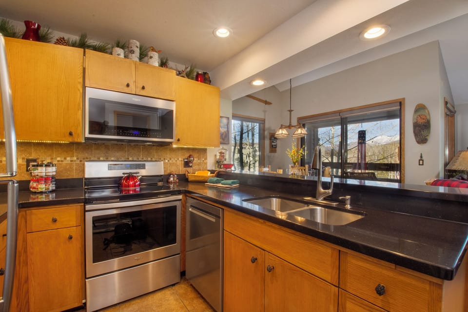 Your fully equipped kitchen awaits with modern appliances and warm wood finishes, perfect for creating memorable meals together.