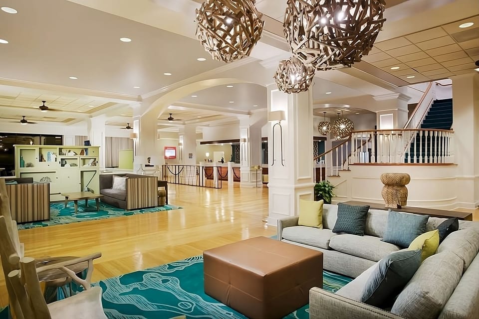 Step into a grand lobby glowing with warm, modern charm.