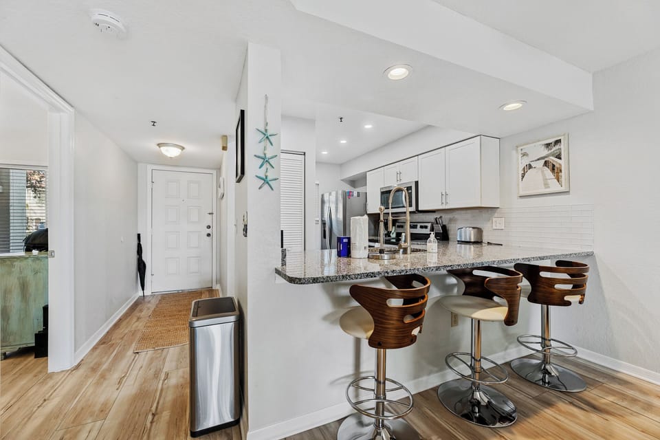 The kitchen has a bar area that sits three