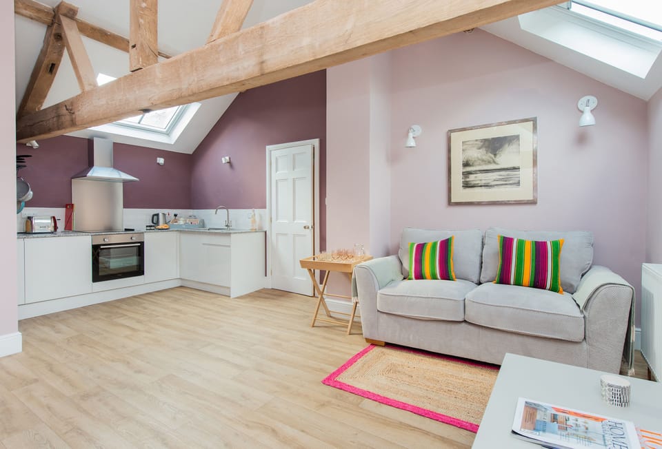 First floor:  Open plan sitting room and kitchen with exposed beams and rafters