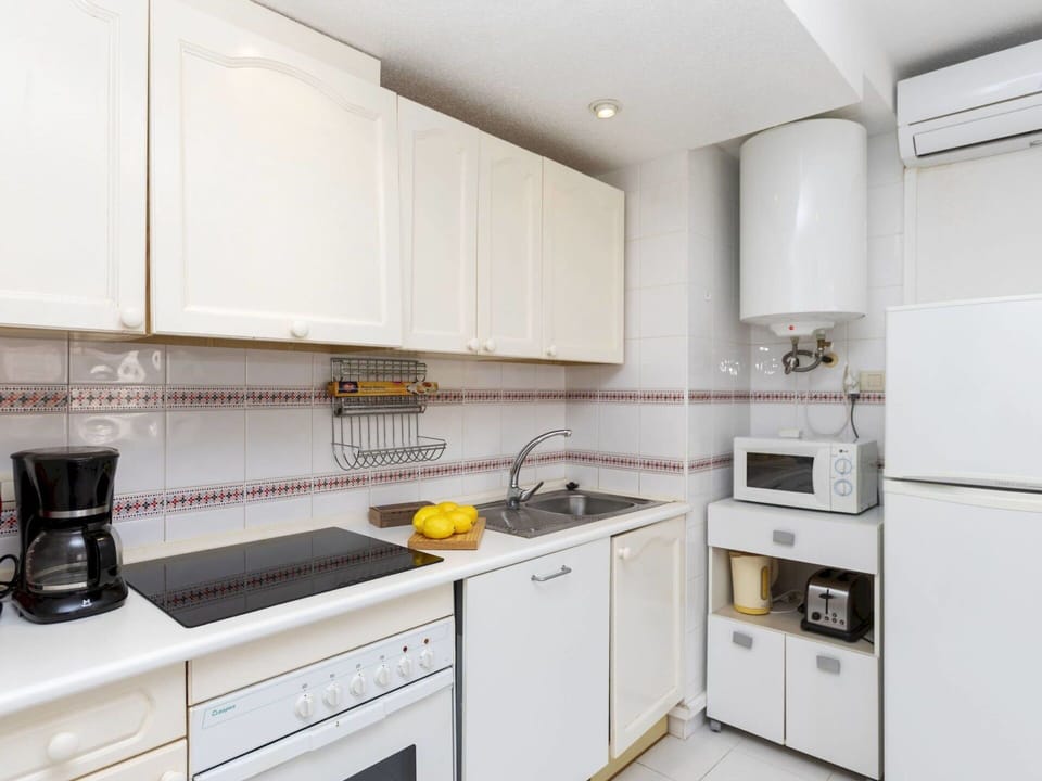Kitchen, Kitchen Appliance, Countertop, Major Appliance, Cabinetry, Flooring, Interior Design, Kitchen Stove, Home Appliance, Stove