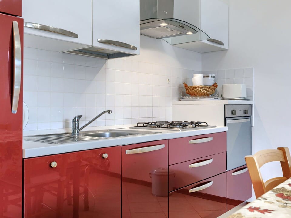 Kitchen, Major Appliance, Kitchen Appliance, Kitchen Stove, Countertop, Cabinetry, Stove, Flooring, Gas Stove, Interior Design