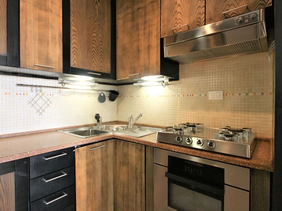 Countertop, Cabinetry, Kitchen, Room, Property, Furniture, Tile, Interior Design, Lighting, Brown