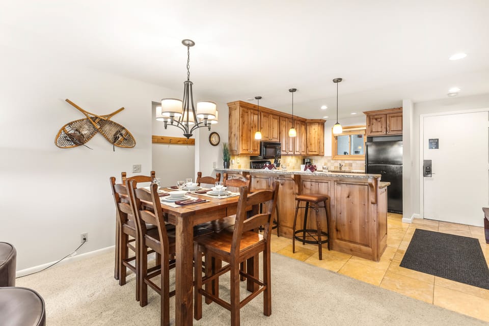 Snow Flower Condominium 14's dining area next to open concept kitchen with additional counter seating.