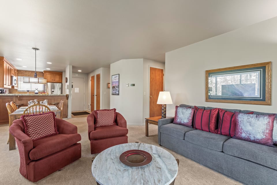 The living room offers comfortable furniture and an open concept.