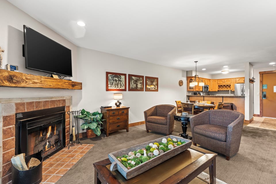 The living room with wood furniture and two upholstered club chairs.