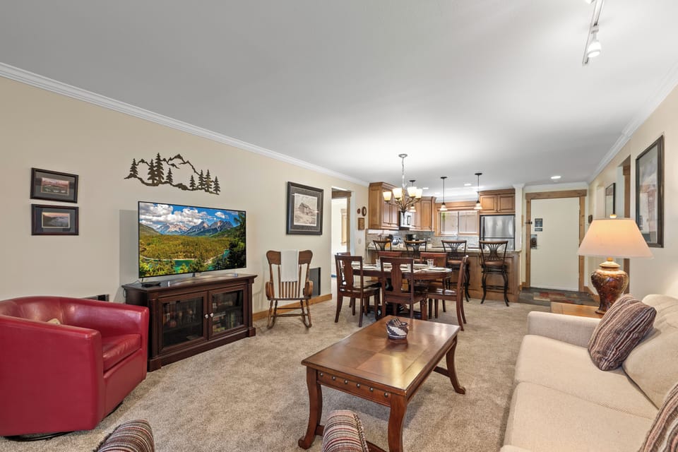 The living room with open concept dining and kitchen area.
