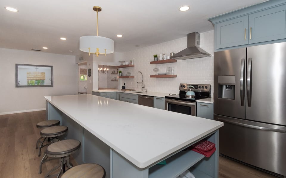 large kitchen island with seating and stainless steel kitchen appliances