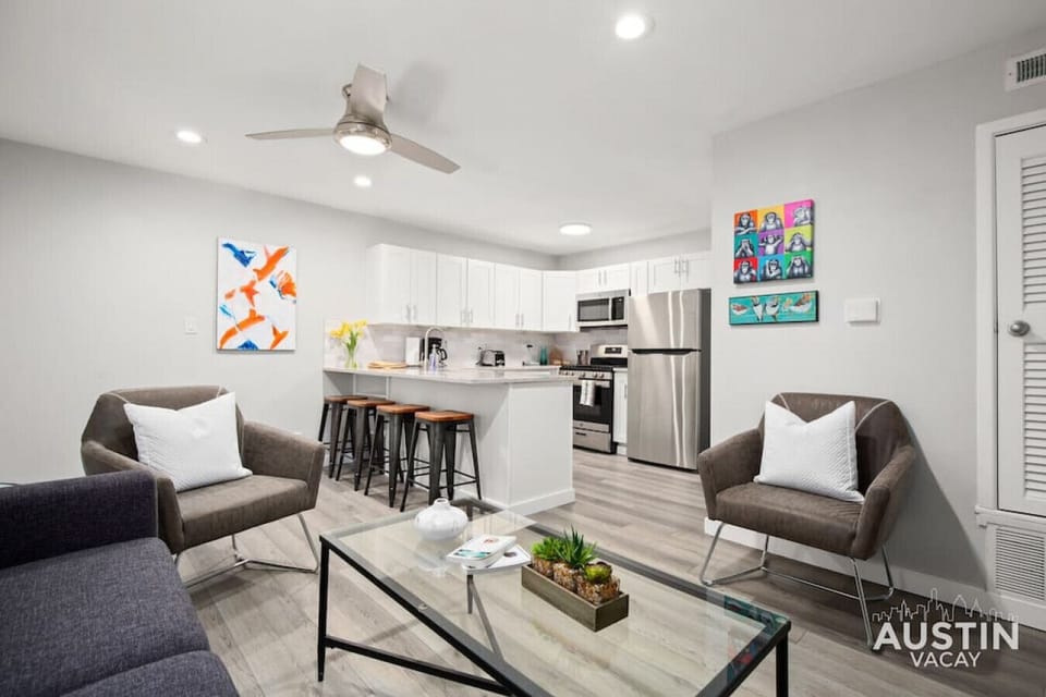 Open concept living room and kitchen with sleeper sofa and smart TV