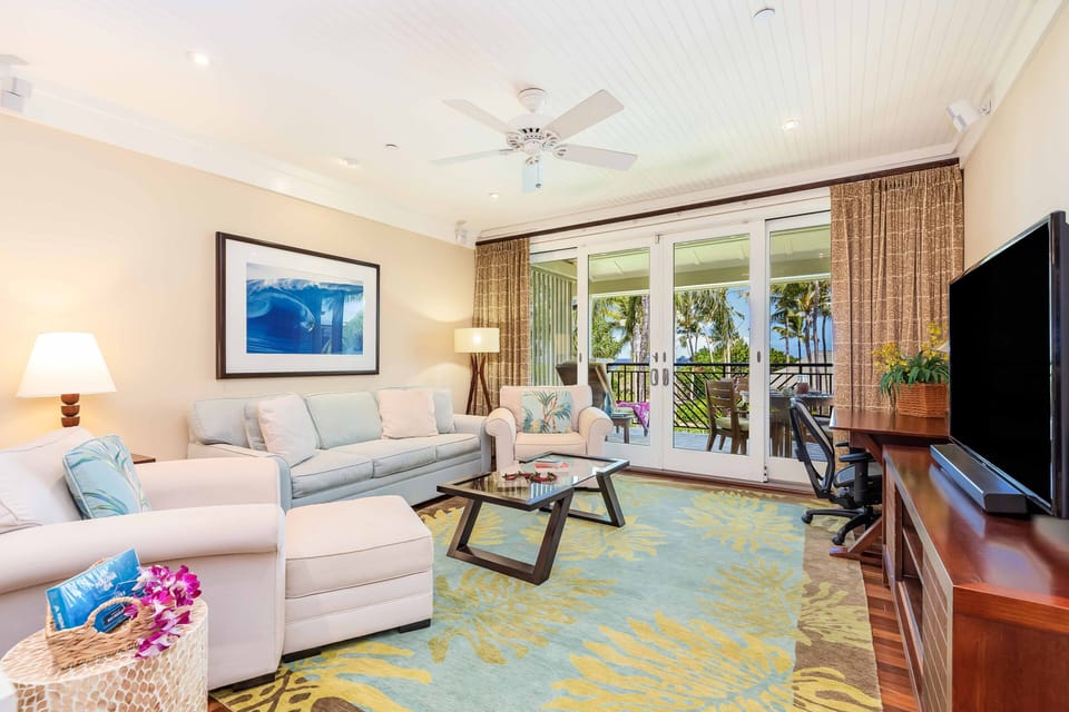 Relax with family and friends in the bright living room, complete with comfortable seating and direct lanai access.