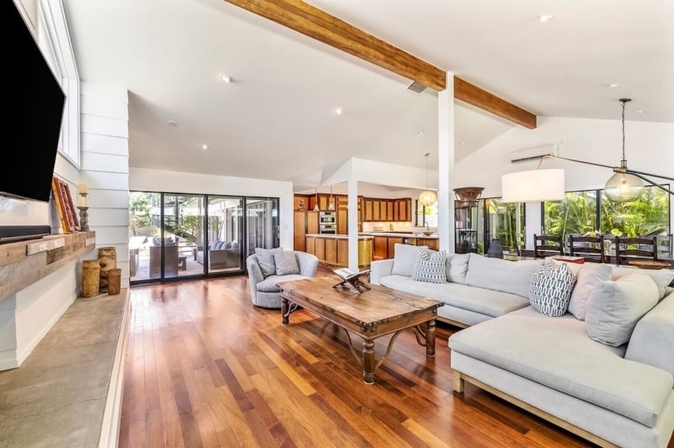 Just through the sliding doors, you'll encounter the tranquil pool deck and covered lanai.