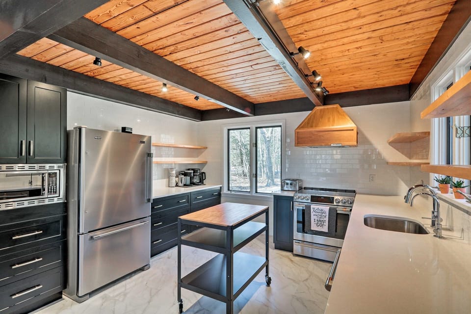The kitchen features all stainless steel appliances.