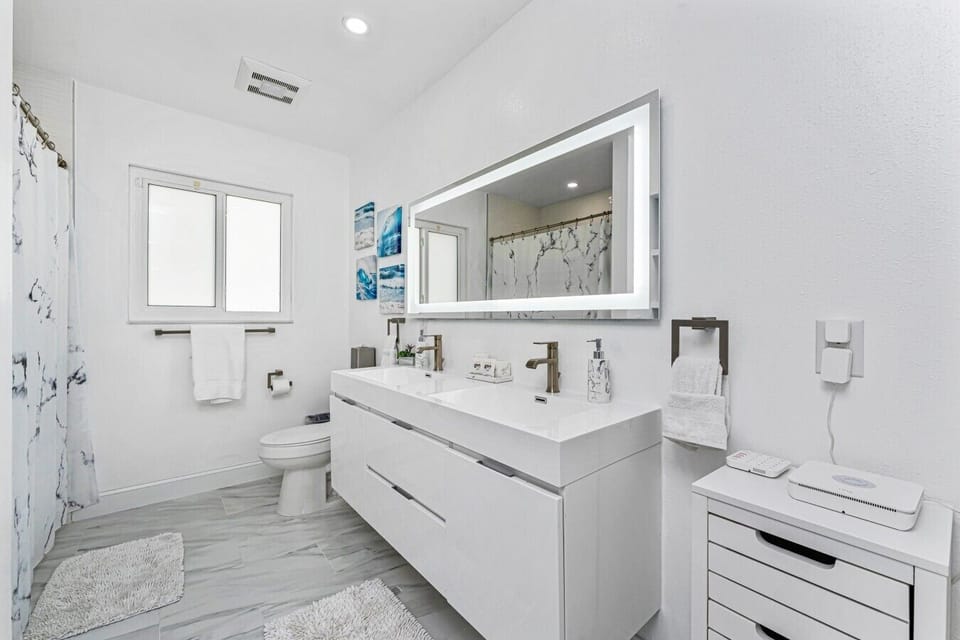Shared bathroom with a double vanity and extra storage