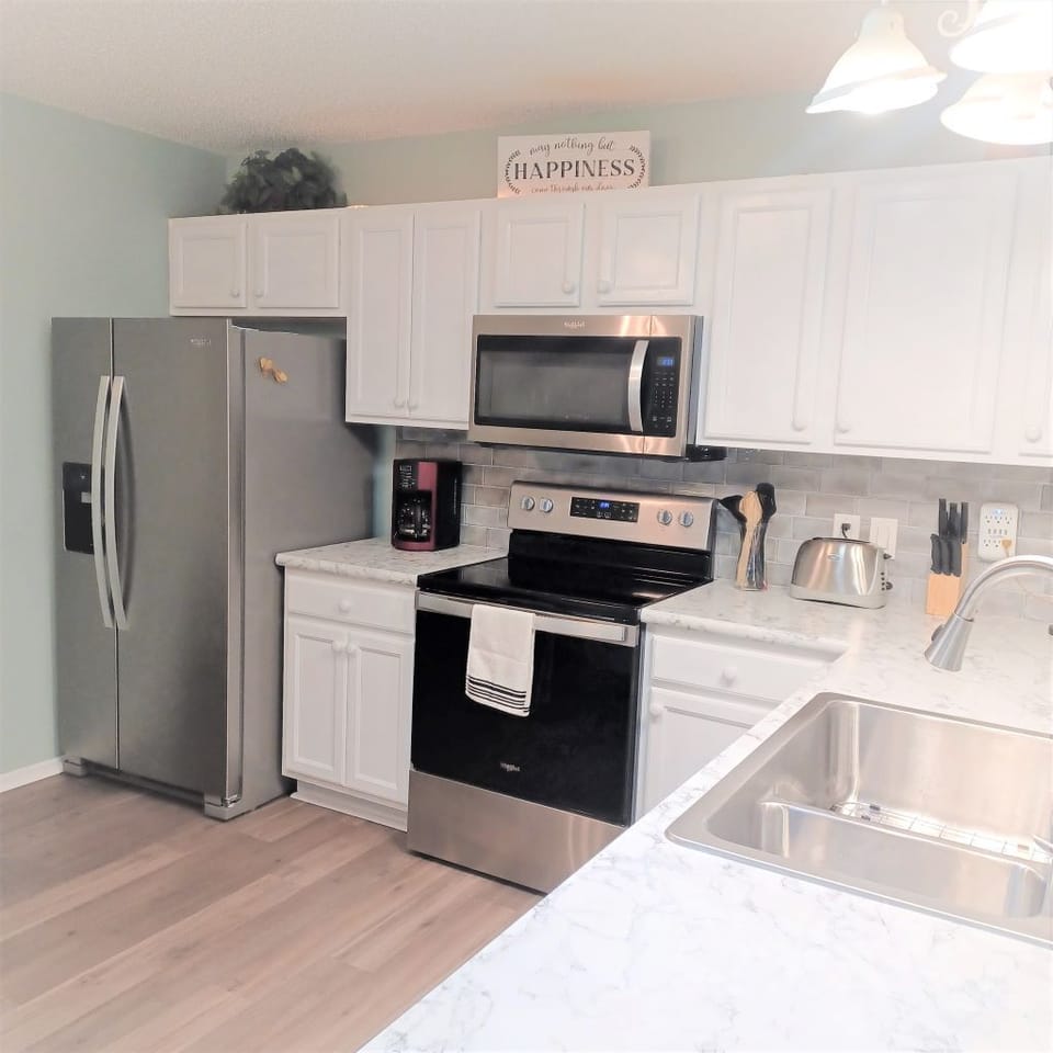 Newly remodeled kitchen, with new cookware and eating utensils.