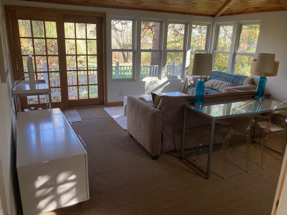 Sunroom with seasonal river view, smart TV, slim desk. Full sized fold out sofa.