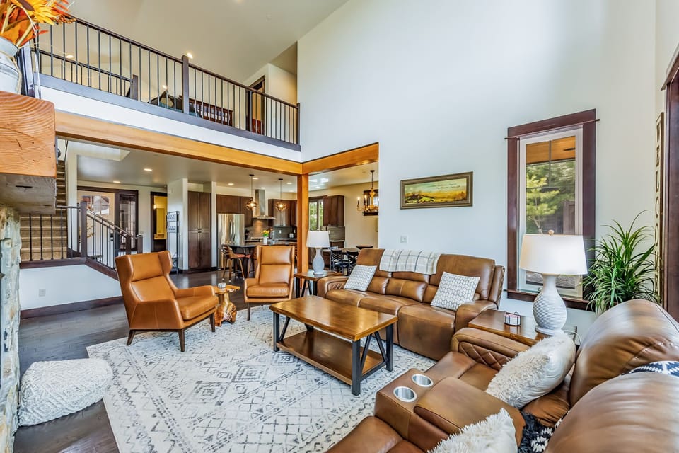 Naturally Well Lighted and Roomy Great Room with very Comfortable Reclining Sofas  and Floor to Ceiling Beautiful Stoned Indoor Face Fire Place