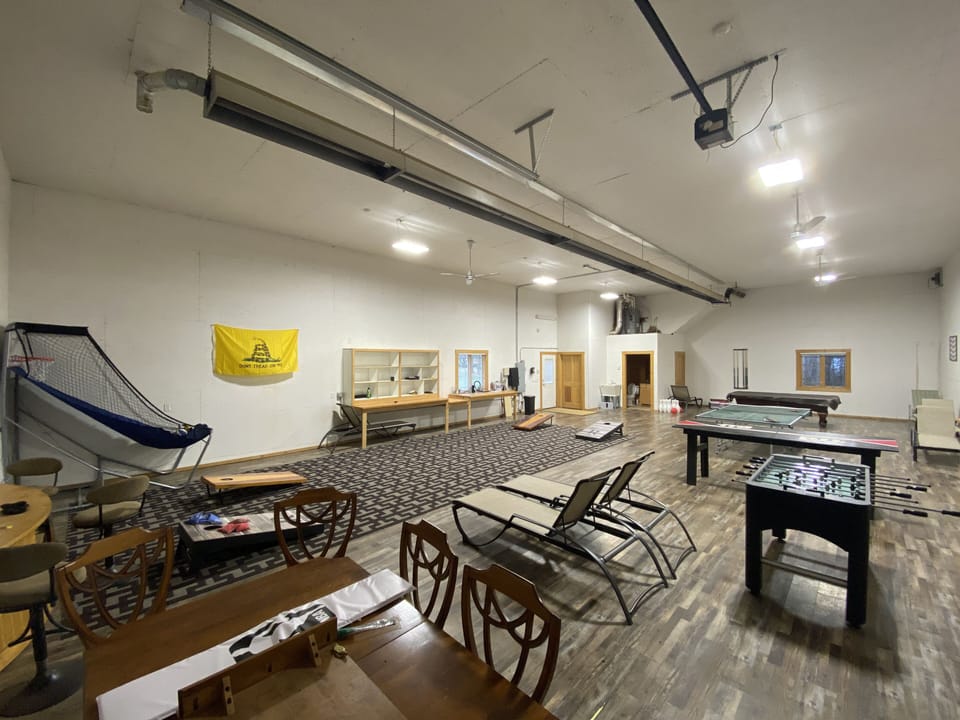 Game Room that includes 2 regulation-size cornhole sets. 20 yards from house