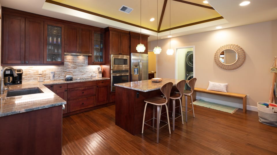 Gourmet kitchen with large island and high end appliances and wine fridge