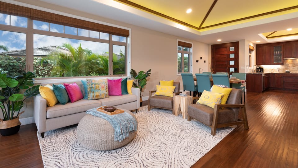 Open concept living area with vaulted grass cloth ceilings
