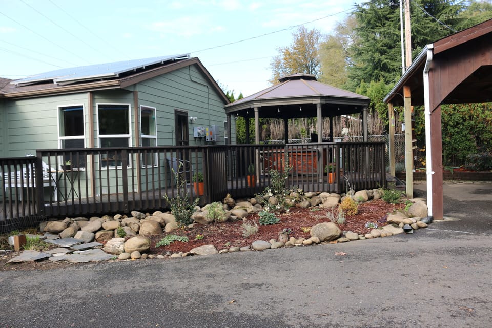 Front of home showing he gazebo area next to covered car port.