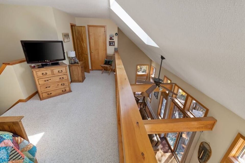 Full sized bed in the loft area with smart tv.