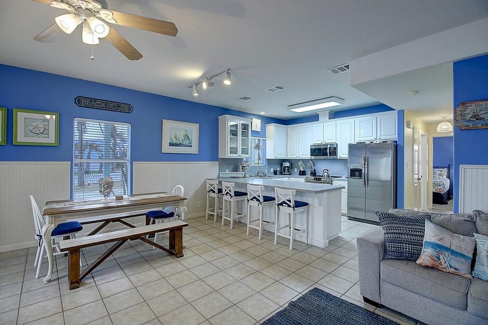 Dinning Area - The kitchen, dining, and living areas are beautifully tie together for a warm, welcoming coastal retreat