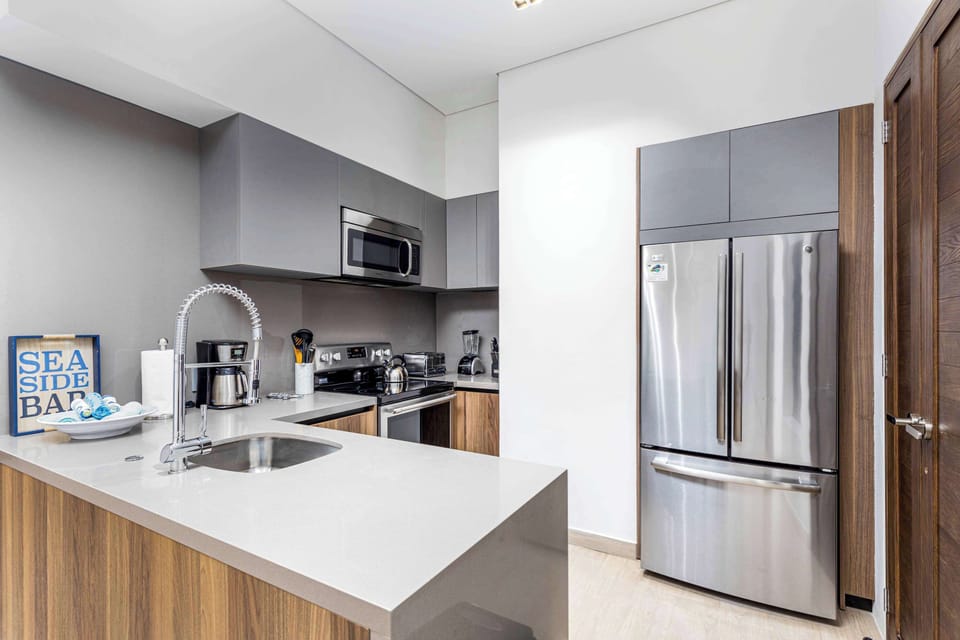 Kitchen equipped with oven, microwave, dishwasher and electric stove.