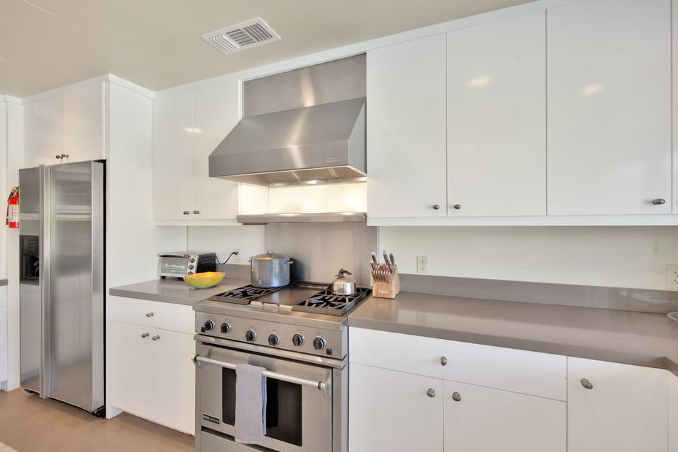 Kitchen features Jenn-Air stove with griddle, espresso machine, 2 sinks.