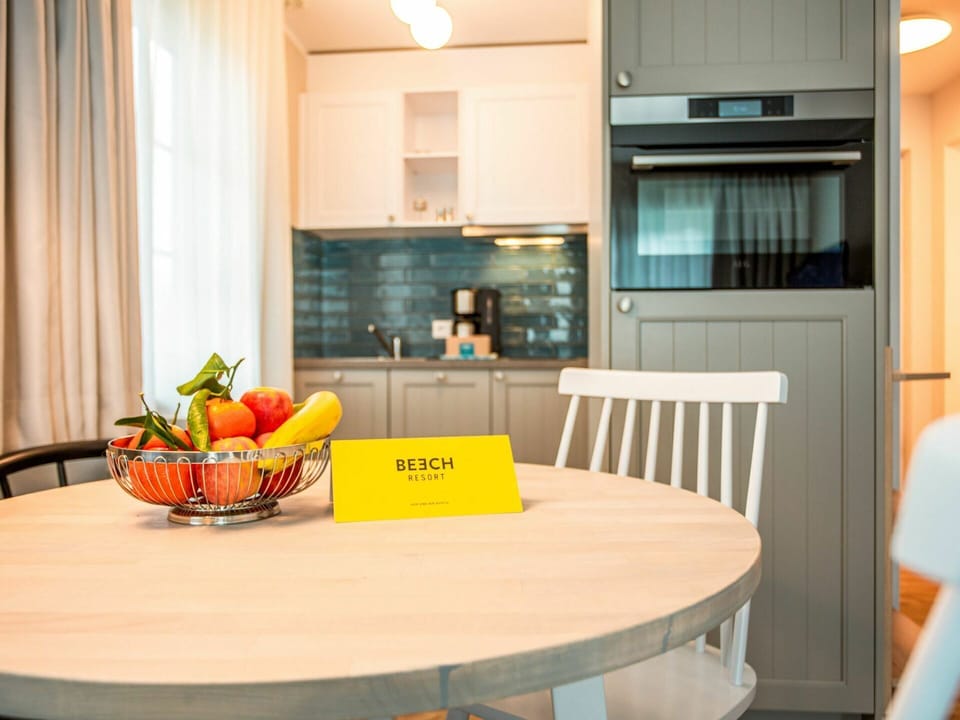Table, Furniture, Food, Cabinetry, Tableware, Building, Interior Design, Orange, Lighting, Wood