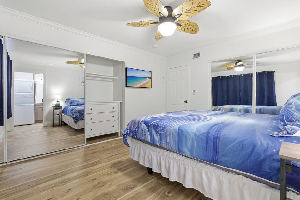 Lower Unit Primary Bedroom – TV, Closet & Room Layout
Additional view highlighting the Smart TV, mirrored closet doors, dresser storage, and the spacious layout of the primary bedroom.
