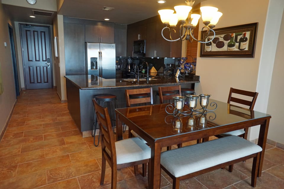 Dining table seats 6 with 4 additional seats available at the kitchen bar