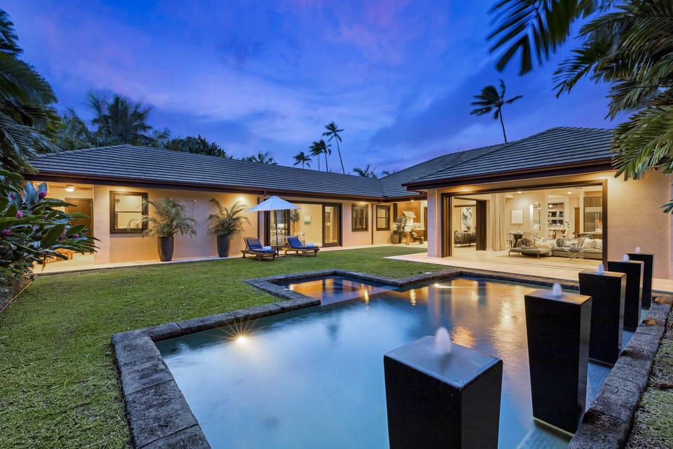 POOL FOUNTAINS - Fountains and lights create a serene landscape as night falls