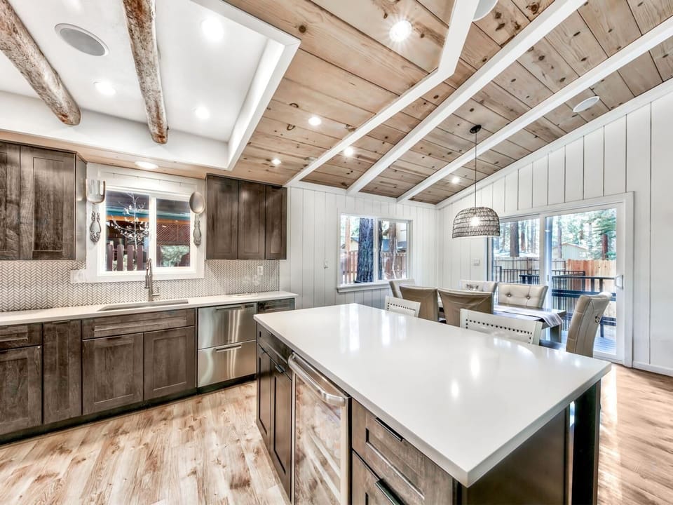 Cook memorable meals in your fully equipped kitchen featuring rustic beams, modern appliances, and a spacious island perfect for gathering.