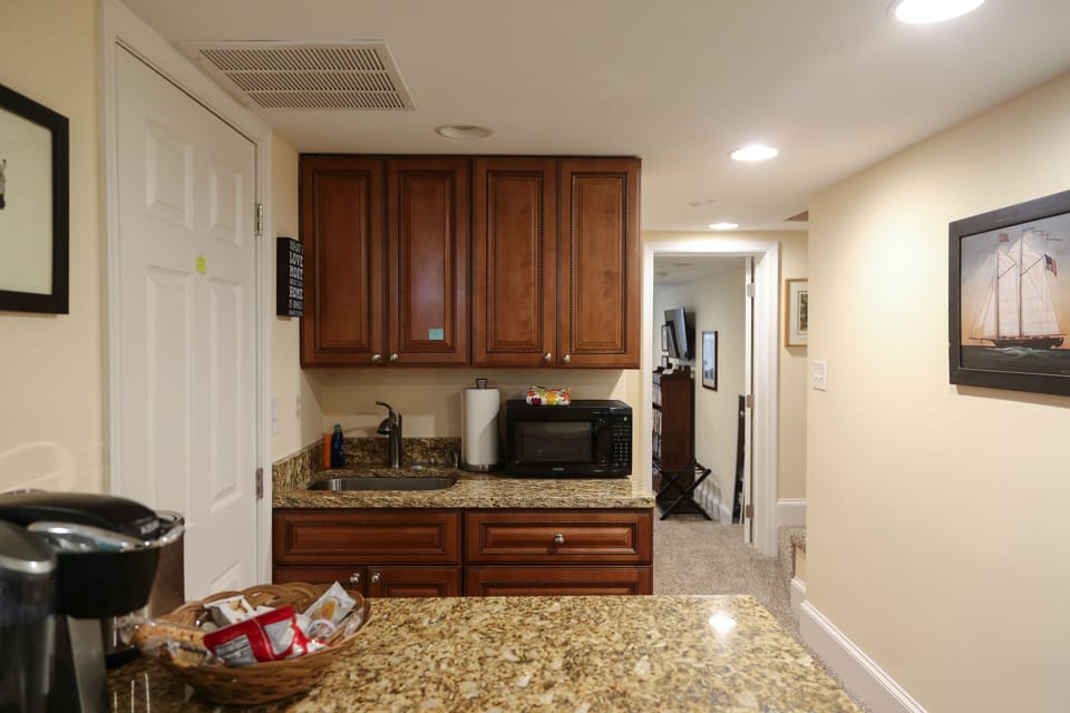 Kitchenette - microwave, sink, Keurig coffee maker, toaster, and refrigerator.