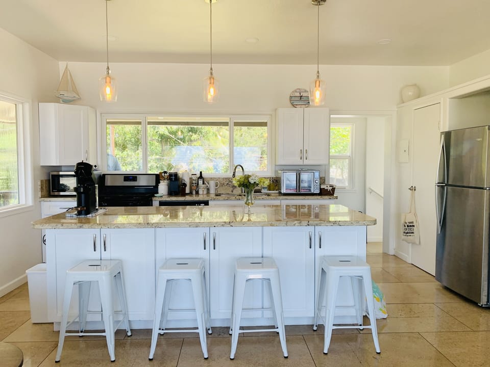 Furnished kitchen with gas range oven, dishwasher, microwave, Keurig machine