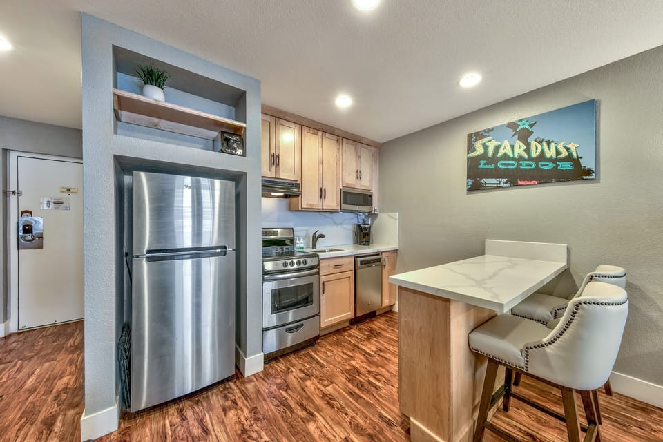 Your fully equipped kitchen awaits with stainless steel appliances, granite counters, and a cozy breakfast bar for morning coffee.