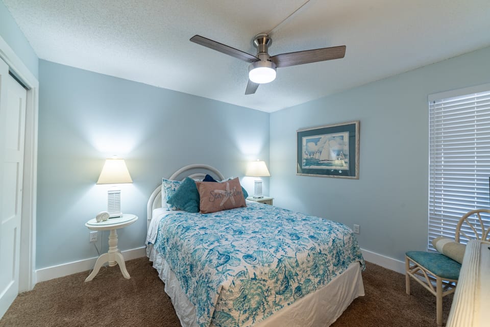 Comfortable queen size bed with overhead ceiling fan
