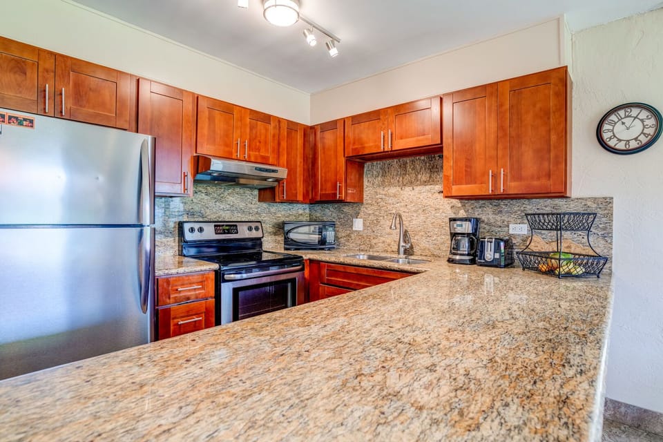 Wonderfully remodeled kitchen featuring granite counter-tops and new stainless steel appliances