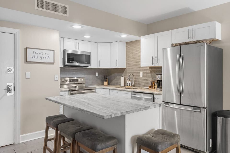 Fully equipped kitchen for all of your cooking needs! Regular drip coffee machine and coffee provided! Seating available at the island. The kitchen opens up to the living room, great for entertaining!