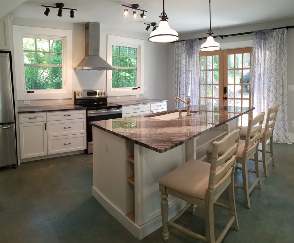 Fully equipped kitchen boasts stainless appliances, grey marble and filtered H2O