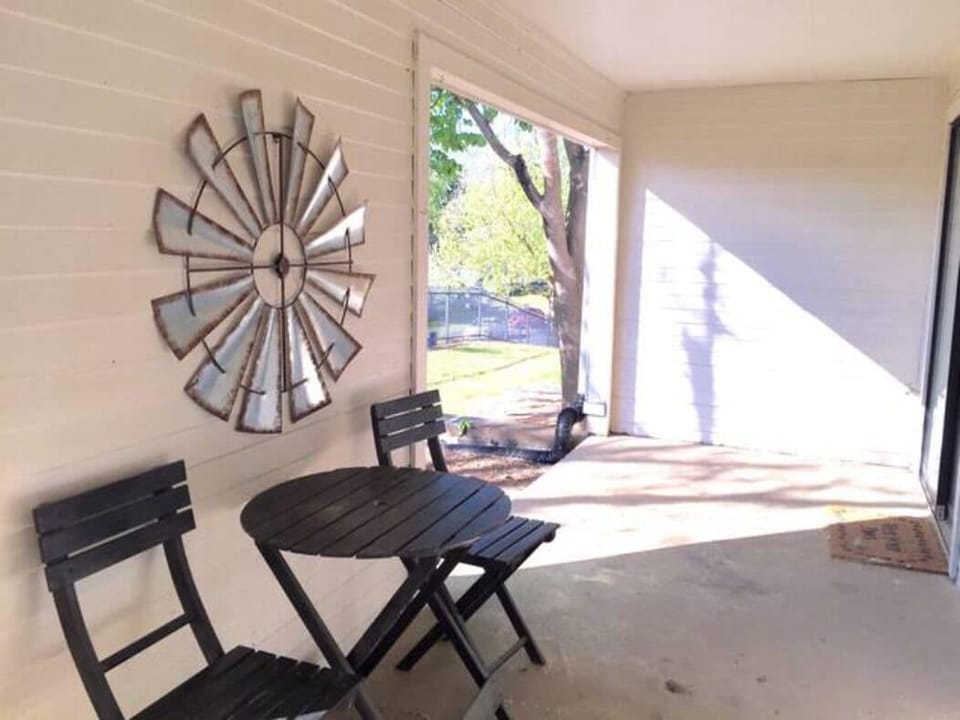 The back patio has a conversation table and chairs. 