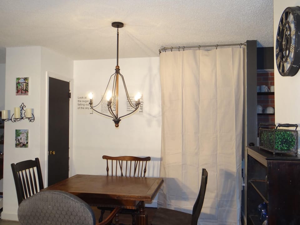 The dining table fits four people. There is also a bar with 2 additional seats. 