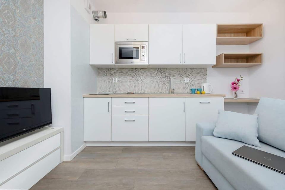 Kitchenette with microwave and refrigerator. 