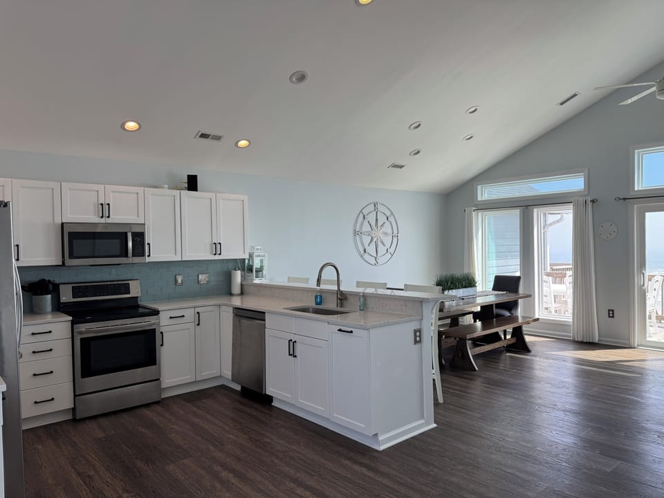 Kitchen with stainless steel appliances and quartz counters