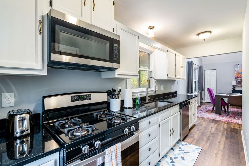 A closer look into the kitchen overlooking entry into dining area.