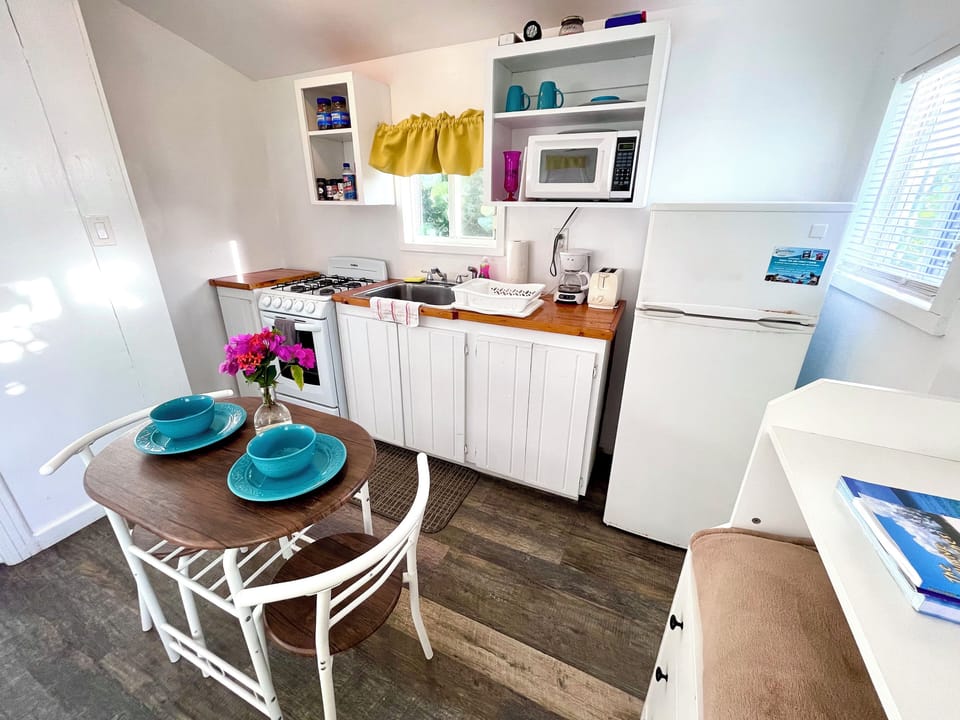 Full size kitchen for in home cooking with ocean views from kitchen window.