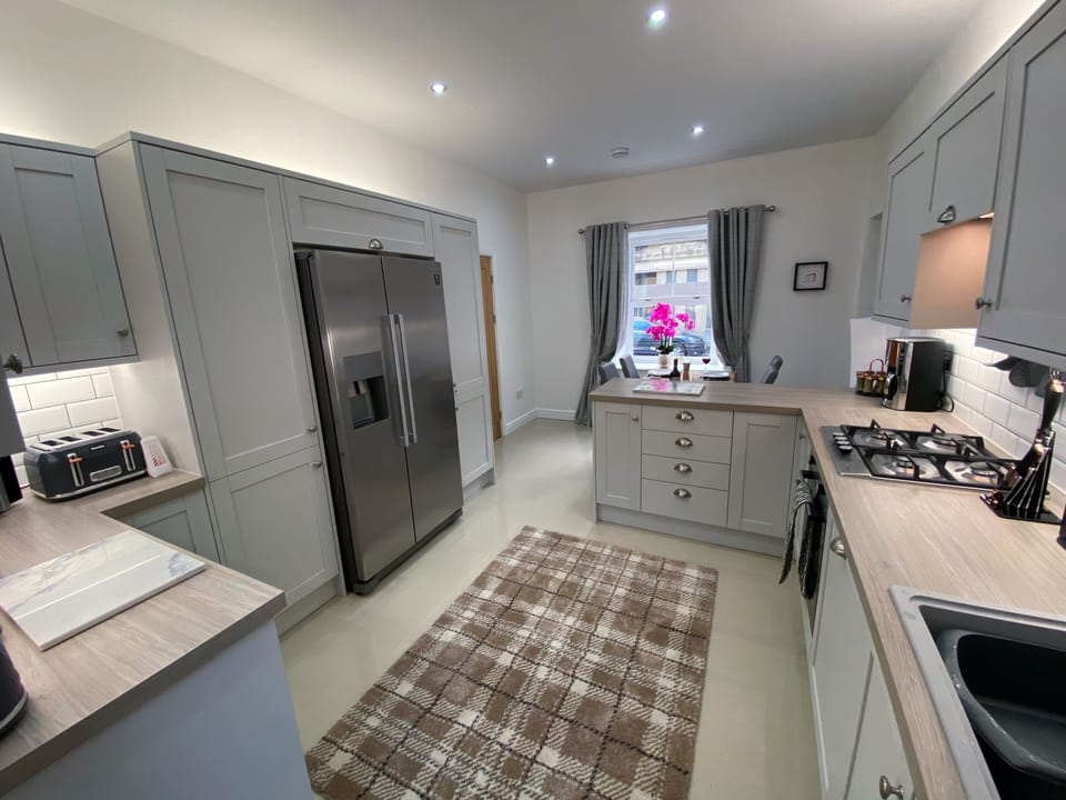 Kitchen with double size American fridge freezer and ice maker.
