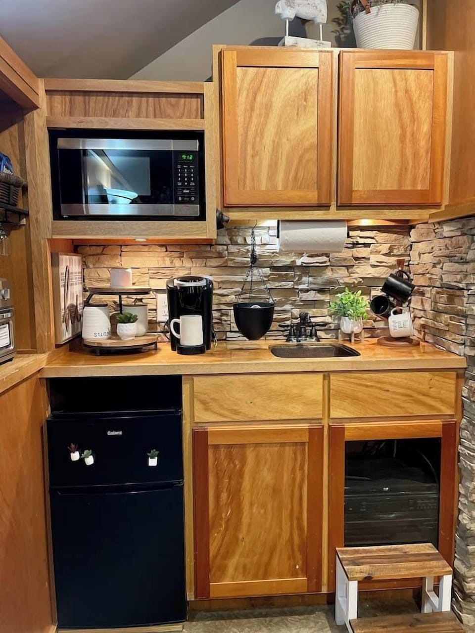Kitchenette area includes small fridge, microwave, coffee station and cuisinart toaster/air fryer oven.  
