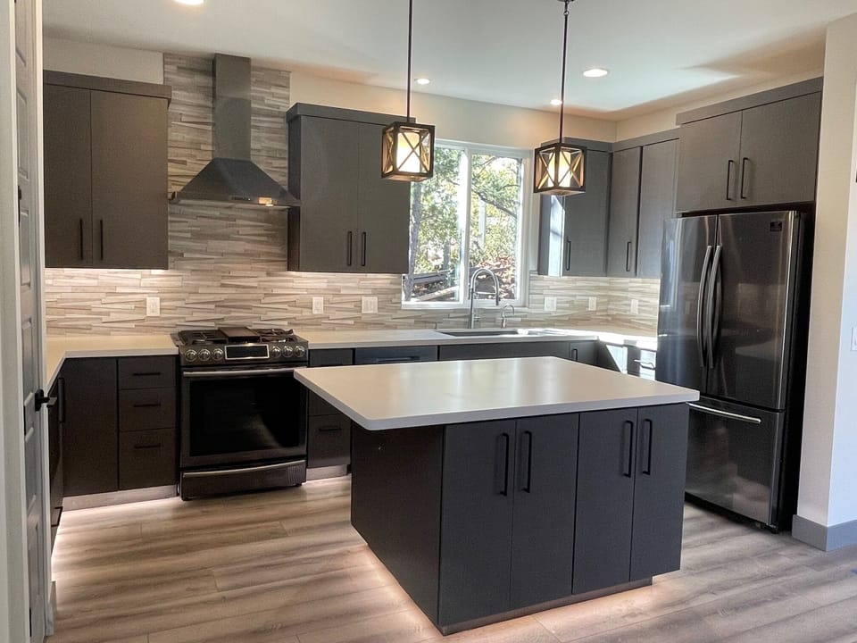 Custom designed kitchen featuring black stainless steel appliances